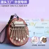 Mini piano de pulgar más vendido transfronterizo, kalimba de cristal acrílico de 8 tonos, instrumento musical tocado con los dedos, adorno colgante popular
