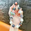 Cadena para teléfono con lazo y cuentas cuadradas transfronteriza, llavero, accesorio colgante de moda para bolso de niña, regalo pequeño, venta al por mayor