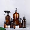 En stock al por mayor botella de vidrio marrón para aceite esencial botella Boston marrón embotellado por separado botella cosmética oscura pistola pulverizadora cubierta de bomba de presión