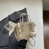 Bolso bandolera de un solo hombro casual elegante de nicho Shuai Mi Jia, moderno bolso cubo para mujer nuevo de verano 2026