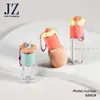 Servicio de Pedidos Jinze: Tapa Redonda en Forma de Flor, 4 Tipos de Botellas Disponibles, Se Puede Colgar con una Cadena, Tubo para Brillo de Labios, Material de Empaque de Plástico