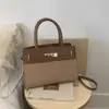 Textura de alta calidad 2026 Verano Nuevo Estilo Color Bloqueo Moda Simple Versátil Elegante Hombro Único Cruzado Portátil Bolso Kelly Cintura
