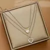 Collar de moda multicapa transfronterizo europeo y americano más vendido, collar con colgante de doble corazón elegante y único para mujer, venta al por mayor