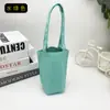 Directo de fábrica color liso lona taza de agua bolso de mano bolsa portátil para bebidas bolsillo de tela taza de mano tapa de taza se puede personalizar LOGOTIPO