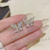 Pendientes de mariposa súper brillantes, dulces y elegantes, para mujer, pendientes de lujo ligero de nicho de alta gama, versátiles, estilo coreano, pendientes de celebridad de internet, venta al por mayor