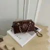 Bolso de mano de cadena con patrón de rombos retro, diseño cilíndrico, colección de otoño para mujer, chic y lujoso, versátil, y exuda una sensación de alta gama, adecuado para llevar al hombro o cruzado