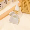 Llavero Popular de Arcilla Transfronterizo Colgante Pequeño Pedrería Metal Regalo de Vacaciones Llavero con Cordón de Cuero Venta al por Mayor