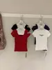 Wgwe9359 Guangzhou Shisanxing Moda Feminina Verão 2026 Novo Estilo Pura Desejo Gola Redonda Ombro Normal Manga Curta Camiseta Top