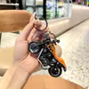Nuevo llavero creativo de mini motocicleta para coche, exquisito colgante de dibujos animados para mochila escolar de niños, regalo al por mayor