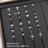 Nuevos y modernos aretes de cruz con diamantes completos Jiuhan para mujer, ear cuffs de acero de titanio de nicho, populares tachuelas de hueso de la oreja de alta gama