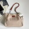 Bolsa feminina 2026 outono nova estilo coreano bolsa escolar estudantil simples moda bolsa de ombro grande capacidade bolsa tote para o dia a dia