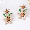 Estilo nacional nueva moda personalidad creativa hermosos pendientes de aleación con gota de aceite de flor pendientes de aceite de flor todo partido pendientes al por mayor