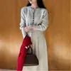 Suéter Cardigan de Gola Redonda Suave de Botão Único + Saia Estilo Francês Novo para Outono e Inverno - Conjunto de Duas Peças da Moda para Mulheres