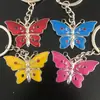 Al por mayor pequeño regalo exquisito color diamante colgante de mariposa en stock llavero multicolor opcional varios patrones láser