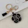 Pingente de chaveiro camélia com franja de couro e strass transfronteiriço, flor de argila com strass criativa, acessório para chaveiro de carro e bolsa