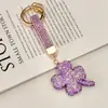 Chaveiro de Carro com Pingente de Trevo de Quatro Folhas da Sorte em Argila Cerâmica Full Strass Transfronteiriço Pingente para Bolsa de Casal de Luxo Pequeno Ornamento Criativo