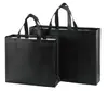 Bolsa no tejida en stock Impresión a color de película Bolso de mano para llevar ropa a domicilio Regalo publicitario Bolsa de compras promocional al por mayor