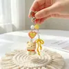 Nuevo Llavero de Cachorro Lindo de Dibujos Animados con Moño de Colores, Colgante de Bolsita en Forma de Corazón, Cuentas de Corazón, Decoración para Mochila