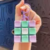Chaveiro pingente de Tetris de nove peças moderno em cores macaron, acessório de brinquedo de botão para alívio do estresse, atacado