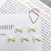 Nuevas Decoraciones para Uñas con Moño de Hada de Color Sólido Brillo Fino Versátil Pajarita Venta al por Mayor Uñas Postizas Aretes Accesorios de Resina