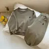 Nuevo conjunto de dos piezas estilo coreano para primavera y otoño, elegante y moderno, para hombres, mujeres y niños, con sudaderas de manga larga de color liso y pantalones