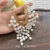 Colar de pérolas com borlas estreladas multicamadas versátil da moda europeia e americana, acessório de corrente para clavícula nupcial requintado de luxo leve francês