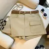 Tiro real Pantalones falda casual coreanos de cintura alta línea A para mujer, versátiles para ir al trabajo, adelgazantes, falda corta color caqui que se ajusta a la cadera con cinturón