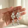 Pendientes largos colgantes con borla en forma de flor dorada para mujer, estilo largo, elegantes y sofisticados, exquisitos pendientes colgantes vintage.