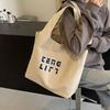 Bolsas Bolsa de Lona Feminina 2025 Nova Bolsa de Ombro Portátil de Lona Grande Capacidade Estudante Ruiying Estilo Japonês Branca Tote