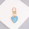 Nueva Joyería Simple Transfronteriza Creativo Colgante de Arena Movediza Ojo del Diablo Colgante de Llavero Metálico con Forma de Corazón Gota de Aceite