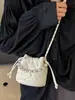 Bolso de cadena con patrón de rombos, bolso tipo cubo de alta moda estilo coreano, nuevo bolso de hombro y cruzado de moda nicho para mujer primavera 2026