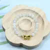 Nuevo brazalete de cristal de piedra ojo de gato con colgante de lirio y lazo, diseño fresco de lujo ligero para novias