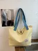 Bolsa de mano casual de nailon estilo coreano, bolso de mano de moda con estampado de letras, popular bolso de hombro de rayas reversible para mujer
