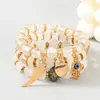 Bestseller transfronterizo Pulsera con colgantes de ala, corazón y ojo turco estilo bohemio, pulsera de cordón elástico de múltiples capas