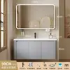 Tocador de baño engrosado y ahorrador de espacio con diseño en color crema, que cuenta con un lavabo redondeado, lavabo cerámico integrado y un lavabo de una sola pieza.