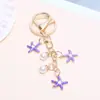Llavero de Estrella de Mar Colorida Transfronteriza Europea y Americana Moda Colgante de Perla de Imitación Colgante para Bolso de Niña Colgante Creativo Personalizado