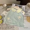 Ropa Infantil Estilo Coreano 2026 Nuevo Verano Conjunto de Dos Piezas para Niñas: Top a Cuadros con Cuello de Muñeca y Shorts con Dobladillo Ondulado