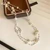 Elegante collar de perlas en capas con cuentas de nariz de cerdo estilo francés, cadena para suéter de temperamento suave, accesorio femenino de lujo ligero de alta gama