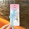 Llavero de campanilla de viento de gato creativo y lindo, colgante exquisito estilo Miu para bolso, llavero popular para regalo pequeño al por mayor