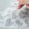 Etiquetas laváveis personalizadas de cola macia em TPU, etiquetas de lavagem transparentes flexíveis para roupas e roupas íntimas infantis, etiquetas de tamanho de roupa impermeáveis sem costura