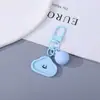 Llavero de resina con cara sonriente suave y linda de color caramelo de macarrón, colgante curativo de nicho, accesorio de llavero con cuentas para DIY