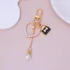 Mini Bolso Colgante Llavero Perla Amor Borla Colgante Niña Funda de Auriculares Decoración Accesorios DIY
