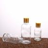 Botella de vidrio para aceite de camelia, tamaño pequeño, 30/50/100 ml, subenvase sellado, boca pequeña, botella vacía de vidrio para prueba de líquido.