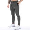 Pantalones deportivos casuales de primavera y otoño para hombre, mallas deportivas para correr, musculosas, con bolsillos y cremallera de color liso.