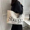 Bolsa de lona de gran capacidad para mujer, bolsa de mano moderna y sencilla con estampado de letras para la escuela, nuevo modelo 2026, bolso de mano y bolso de hombro artístico
