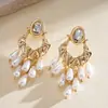 Pendientes de borla de flor de concha blanca transfronterizos europeos y americanos con perlas, pendientes de estilo de corte francés, pendientes ligeros y lujosos con un toque de alta gama