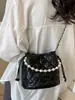 Bolso de cadena con patrón de rombos, bolso tipo cubo de alta moda estilo coreano, nuevo bolso de hombro y cruzado de moda nicho para mujer primavera 2026