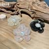 Versión coreana de Dongdaemun 2023 nueva flor de organza de color mágico Anillo para el pelo de perla Accesorios para el pelo de estilo extranjero Joyería de cabeza de bola