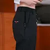 Pantalones casuales de seis bolsillos, estilo fino para primavera y otoño, cintura semi-elástica para hombre, versátiles para jóvenes y de mediana edad, pantalones rectos holgados de negocios al por mayor