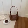 Moda casual de tendencia transfronteriza 2026 verano nuevo popular bolso de mano para axila de mujer, bolso tipo empanada, bolso de hombro y bandolera